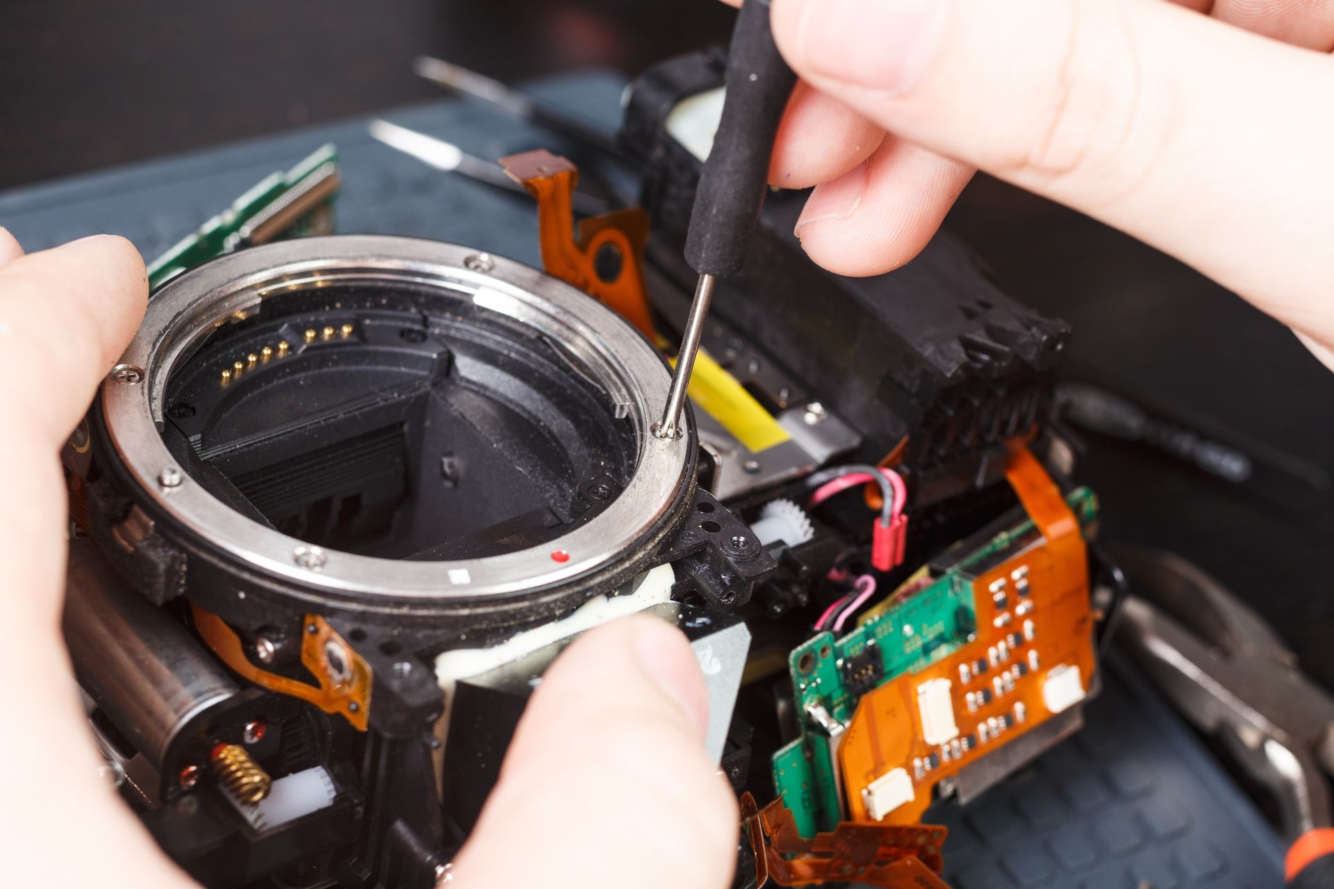 Repair broken digital SLR camera service center closeup.